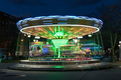 Illuminated ferris wheel at night