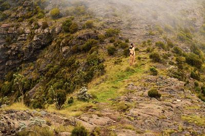 A hiker taking a photo in the panoramic mountain landscapes in rural kenya