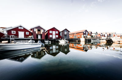 Reflection of buildings in lake against sky