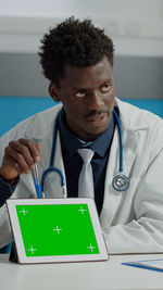 Doctor showing digital tablet in clinic