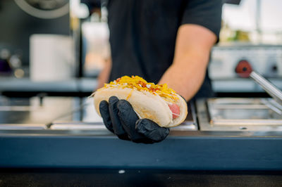 Midsection of man holding sushi