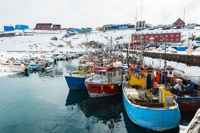 Boats moored at harbor