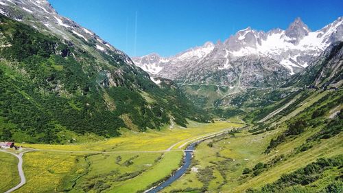 Scenic view of snowcapped mountains against clear sky