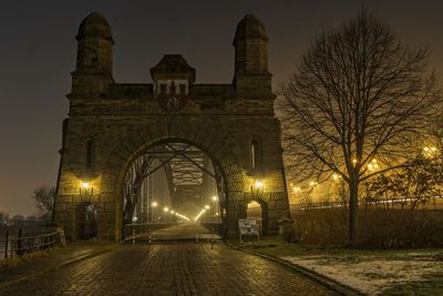 Illuminated bridge against sky at night