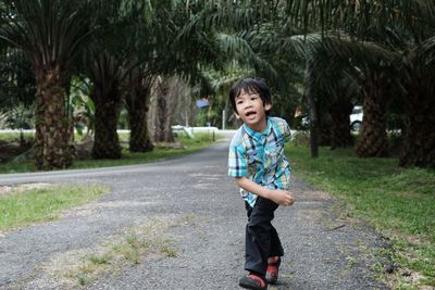 Full length of boy running in park