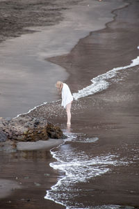 Full length of woman standing on shore