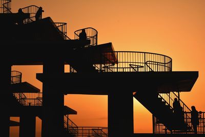 Low angle view of silhouette staircase against sky during sunset