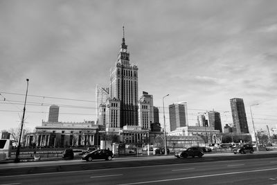 View of city buildings against cloudy sky