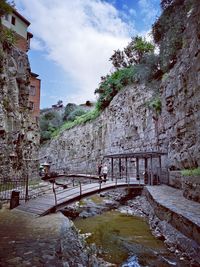 Bridge over canal against buildings