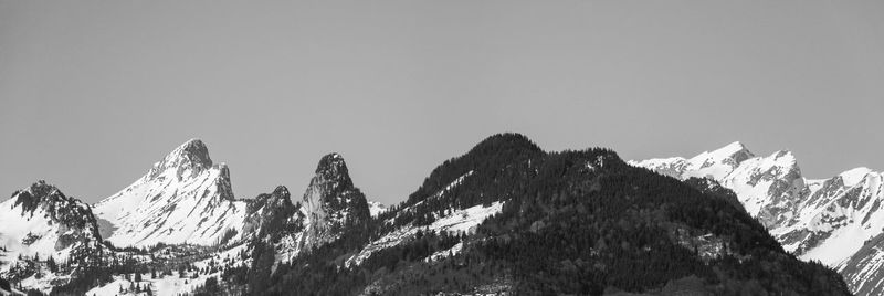 Scenic view of snowcapped mountains against clear sky