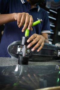 Midsection of man working in workshop