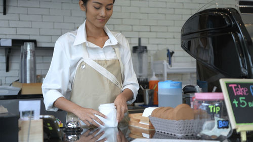 Midsection of woman working at market stall