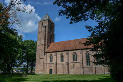 Low angle view of bell tower against sky