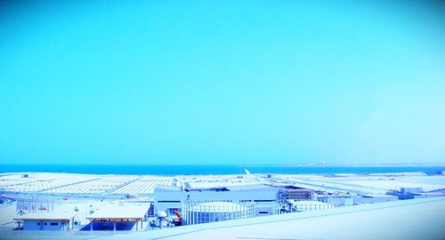 Scenic view of beach against clear blue sky