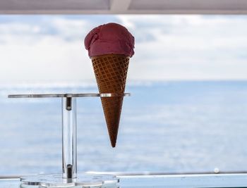 Close-up of ice cream against sea