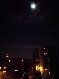 Illuminated cityscape against sky at night