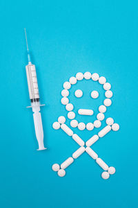 High angle view of blue colored pencils over white background