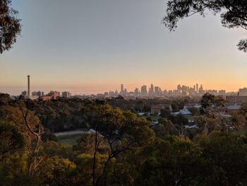 Buildings in city at sunset