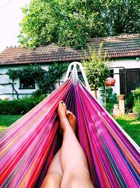 Low section of woman relaxing on hammock