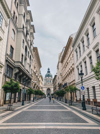 Street amidst buildings in city against sky