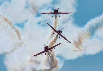 Low angle view of airshow against sky