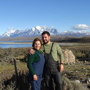 Portrait of young man standing on mountain against sky
