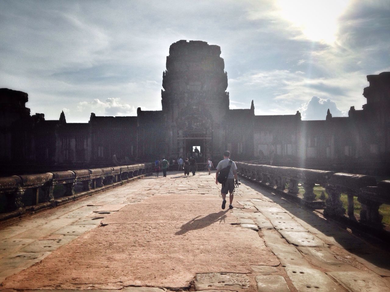 architecture, built structure, building exterior, men, sky, walking, lifestyles, leisure activity, person, full length, history, silhouette, rear view, city, sunlight, famous place, cloud - sky, travel destinations