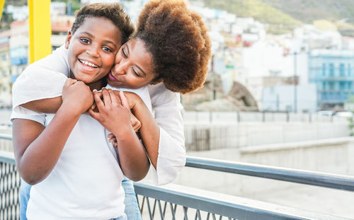 Woman carrying lesbian girlfriend on back in city