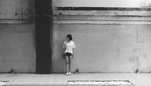 Rear view of man standing against wall