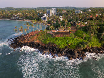 High angle view of townscape by sea against sky