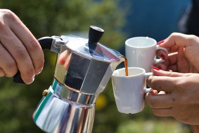 Close-up of hand holding coffee cup