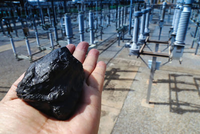 High angle view of person holding coal