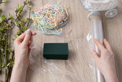 Cropped hands of woman holding nail polish