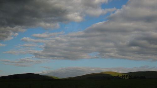 Scenic view of mountains against cloudy sky