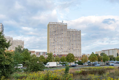 View of modern buildings against cloudy sky