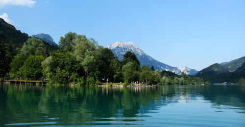 Scenic view of lake and mountains against clear sky