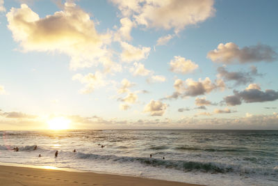 Scenic view of beach against sky during sunset