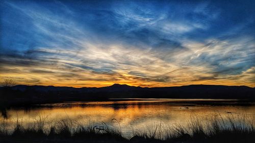 Scenic view of lake against sky during sunset