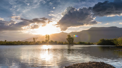 Scenic view of lake against sky during sunset