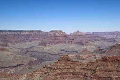 Rock formations on landscape against clear sky