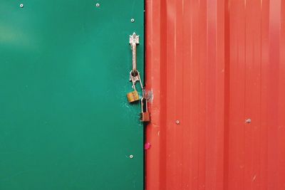 Close-up of padlock on red door