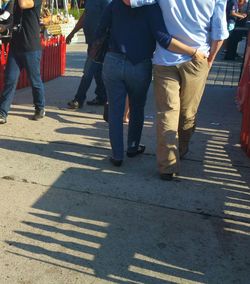 Low section of man walking on street