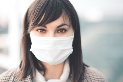 Portrait of young woman wearing mask