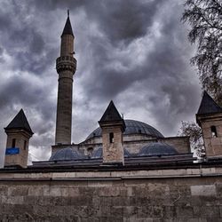 Low angle view of church against cloudy sky