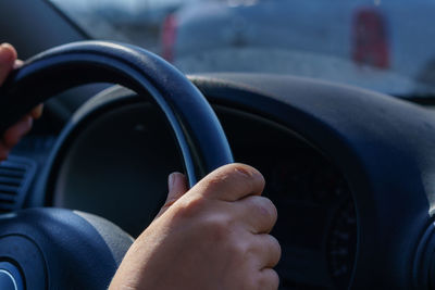 Close-up of hand holding car windshield