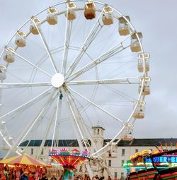 Low angle view of ferris wheel against sky