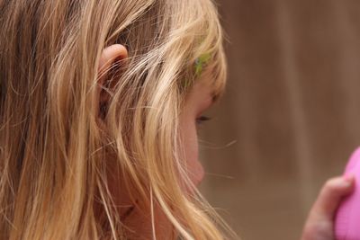 Close-up of girl with blond hair at home