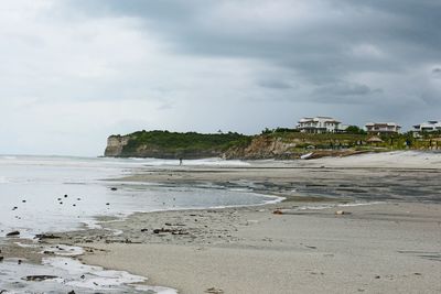 View of beach against cloudy sky