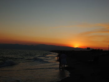 Scenic view of beach against sky during sunset