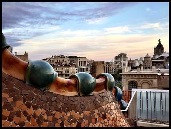 Close-up of sculpture against cityscape